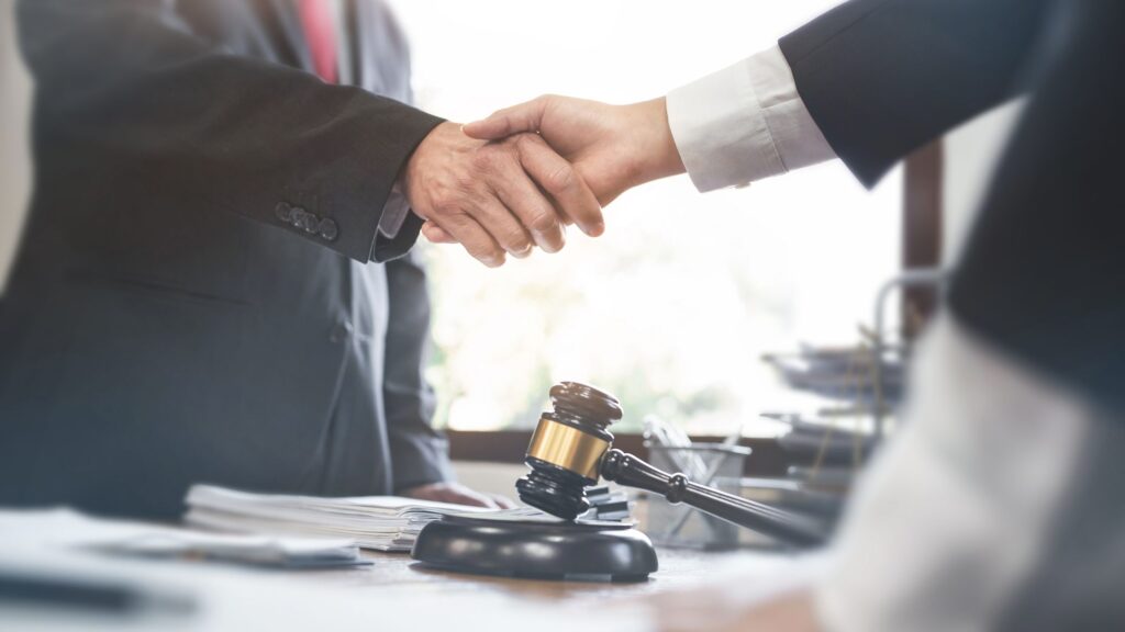 Client confidently shaking hands with a Gulfport side collision lawyer, symbolizing a partnership committed to securing justice in Gulfport, MS.